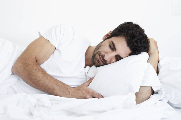 Fast asleep man lying in bed - Фото, зображення