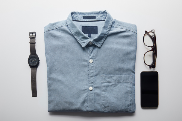 plano de camisa, teléfono inteligente y gafas aisladas en blanco
 - Foto, imagen