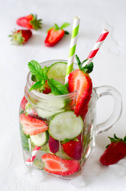 Summer refreshing iced drinks with cucumber and strawberry on white background - Foto, Imagen