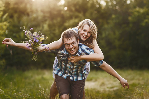 happy fun loving couple walking outdoors in summer - Fotografie, Obrázek