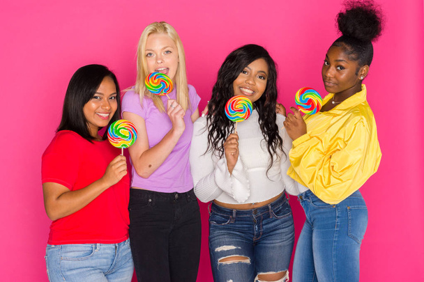 Group of female diverse teenage friends on pink background - Foto, afbeelding
