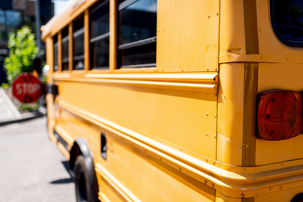 partial view of traditional school bus with stop sign - 写真・画像