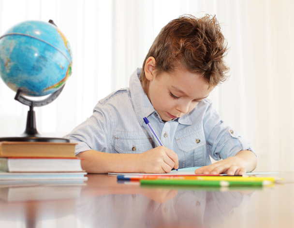 Little boy does a homework - Foto, afbeelding
