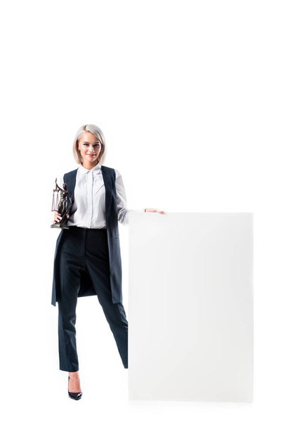 smiling lawyer with temida in hand standing at blank banner isolated on white - Foto, afbeelding