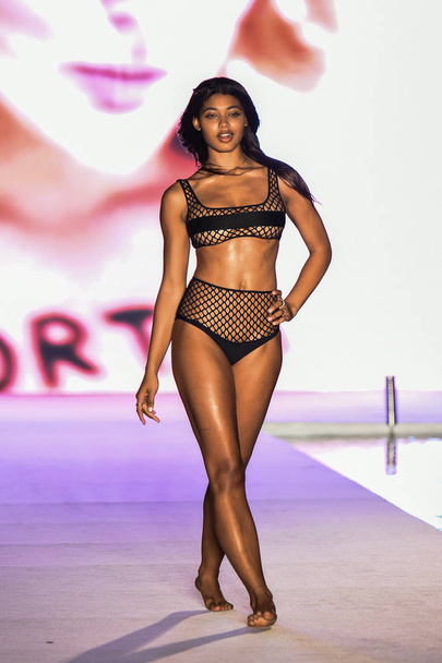 MIAMI, FL - JULY 15: A model walks the runway for the 2018 Sports Illustrated Swimsuit show at PARAISO during Miami Swim Week at The W Hotel South Beach on July 15, 2018 in Miami, Florida. - Foto, Imagem