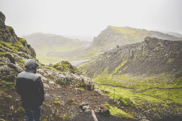 Man looking out from the top of a mountain in Iceland.  Travel wanderlust concept. - Valokuva, kuva