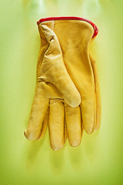 Protective gloves on yellow background. - Zdjęcie, obraz