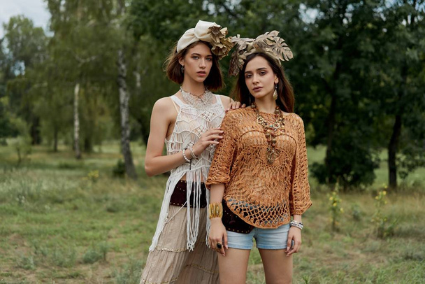 two beautiful young women in elegand headdresses posing outdoors - Foto, Bild