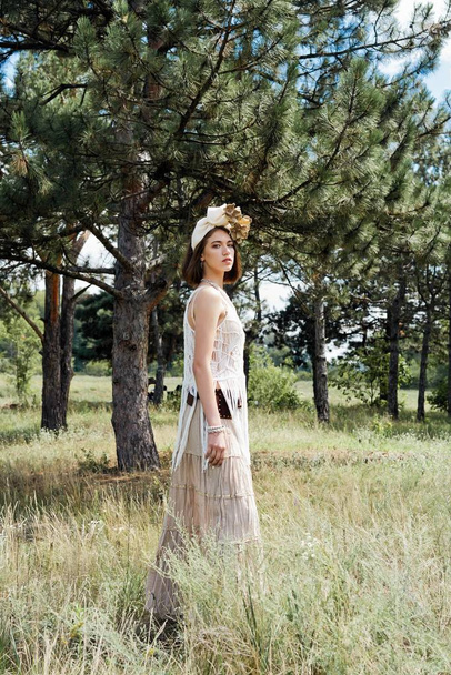 beautiful young fashion portrait of young woman in boho style clothing posing outdoors  - Fotó, kép