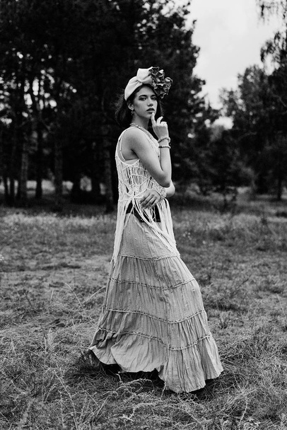beautiful young fashion portrait of young woman in boho style clothing posing outdoors  - Фото, изображение