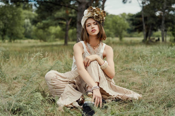 beautiful young fashion portrait of young woman in boho style clothing posing outdoors  - Photo, Image