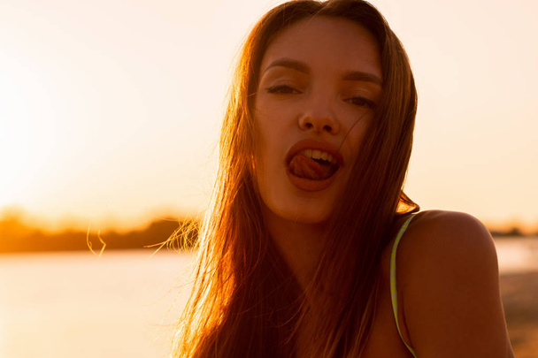 young sexual lady in the sea at warm sunset - Foto, Imagem