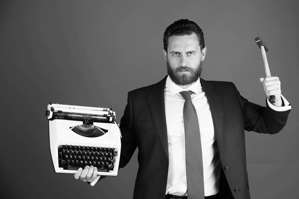business man, aggressive businessman with typewriter and hammer - Foto, imagen