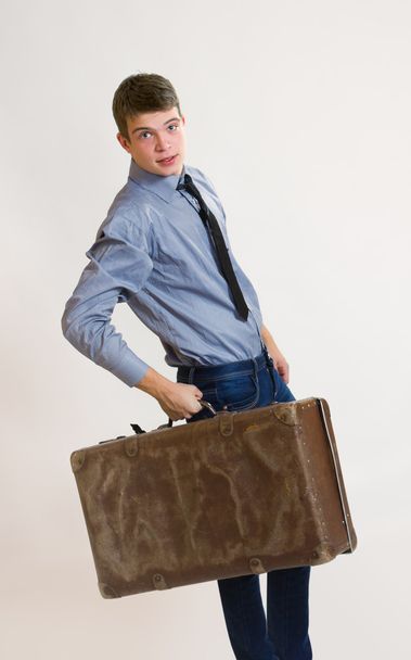 Young businessman holding his old suitcase - Φωτογραφία, εικόνα