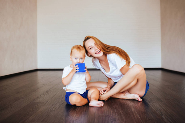 Young mother with her little son are posing. Casual lifestyle photo. - Photo, image