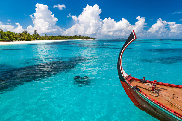 Amazing Maldives beach scene. Wooden boat called Dhoni, traditional Maldivian boat - Photo, Image