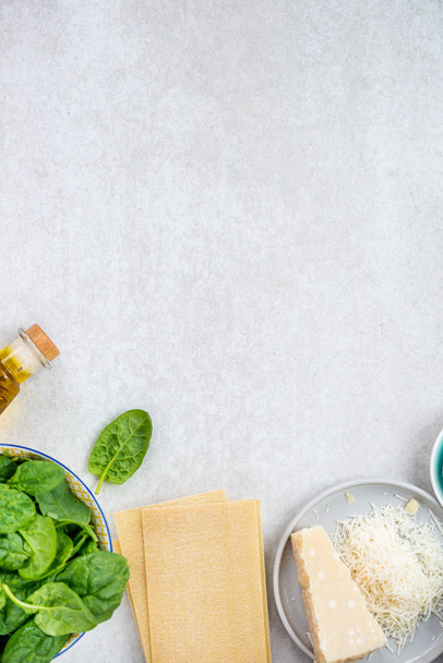 Ingredients for Vegetarian Spinach and Ricotta Lasagna, top view, grey background  - Foto, Imagem