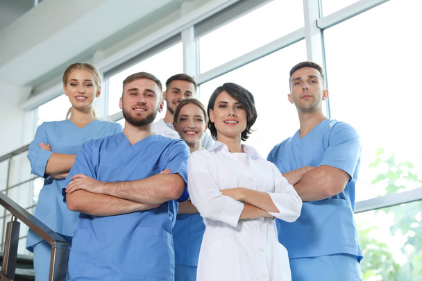 Team of doctors in uniform at workplace - Фото, изображение