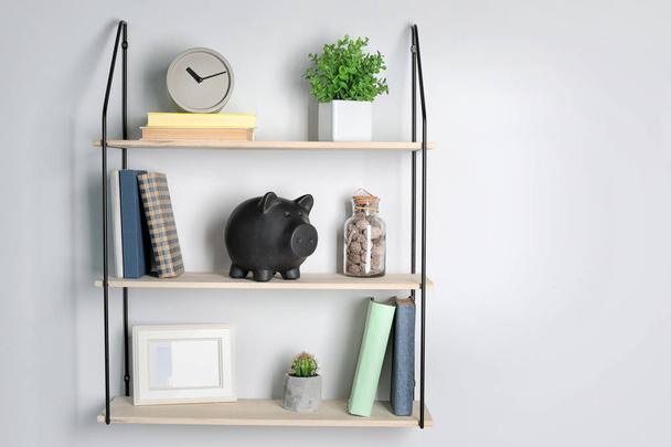 Cute piggy bank on shelf indoors. Stylish interior - Φωτογραφία, εικόνα