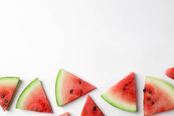Slices of ripe watermelon on white background, top view - Foto, imagen