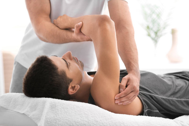 Young man receiving massage in salon, closeup - Photo, image