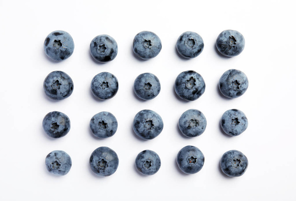 Flat lay composition with tasty blueberry on white background - Fotó, kép