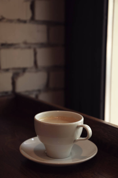 Cup of fresh aromatic coffee on table - Фото, зображення