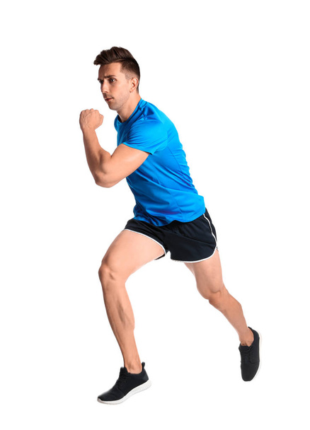 Sporty young man running on white background - Photo, Image
