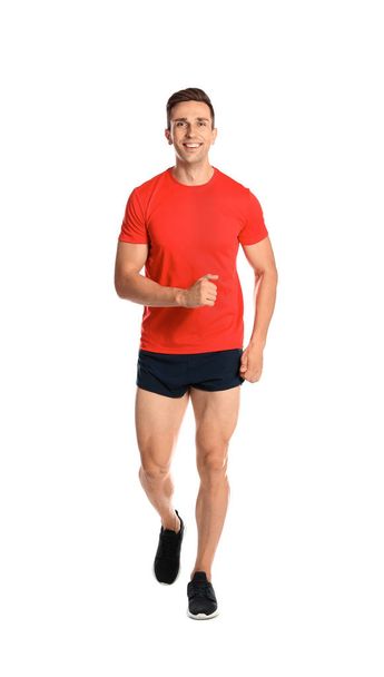 Sporty young man running on white background - Foto, afbeelding