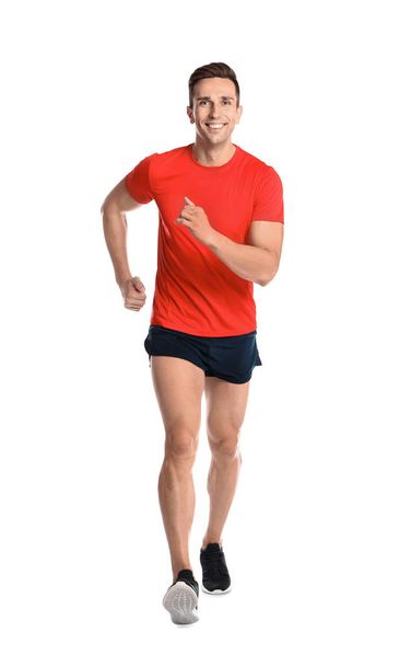 Sporty young man running on white background - Φωτογραφία, εικόνα