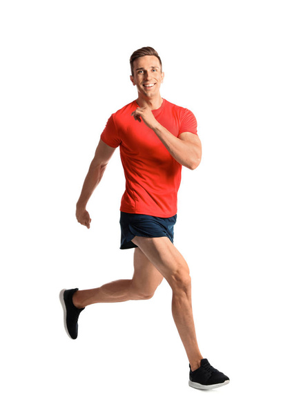 Sporty young man running on white background - Foto, Imagem