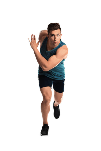 Sporty young man running on white background - Fotó, kép