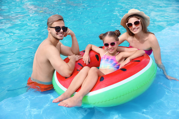 Happy family in pool on sunny day - Foto, Imagen