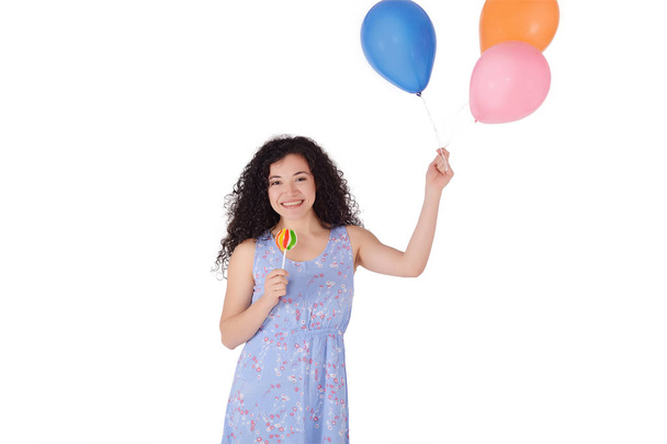 Portrait of beautiful latin Woman having fun with sweet lollipop and baloons. Isolated white background. - Foto, Imagem