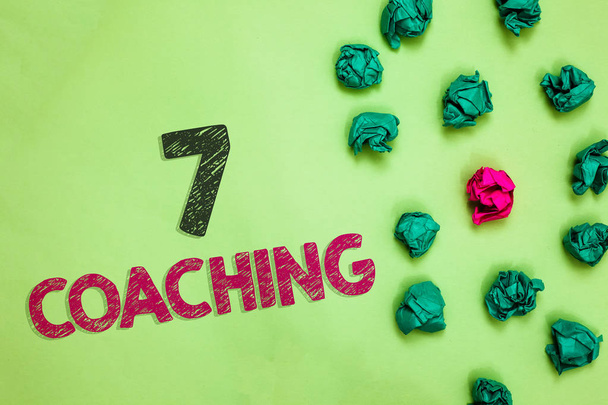 Text sign showing 7 Coaching. Conceptual photo Refers to a number of figures regarding business to be succesful Crumpled wrinkled papers one different pink unique special green background - Photo, Image