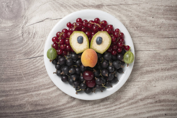 Creative idea of making a face from various berries - Фото, изображение