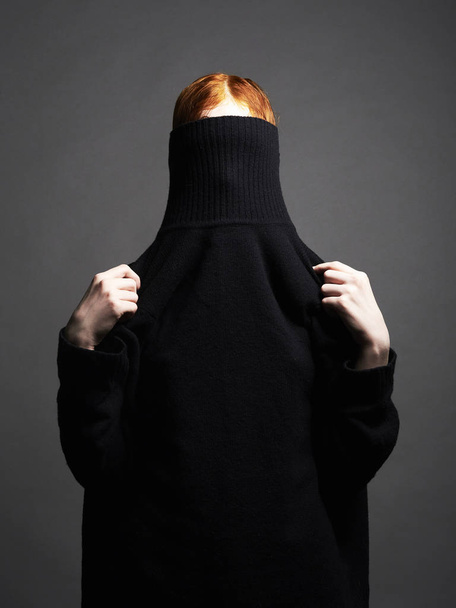 woman in black turtleneck. red hair girl posing in studio - Фото, зображення