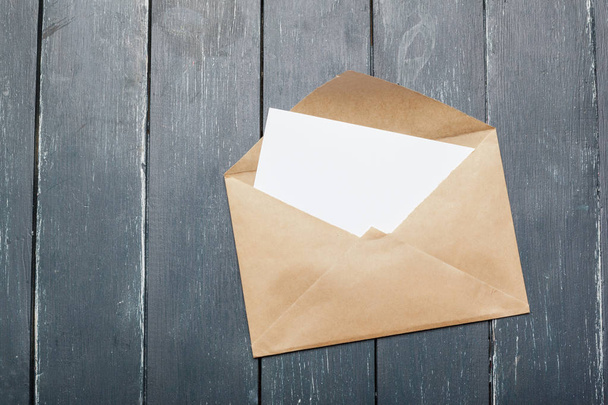 Photo of blank envelope on wooden background - Fotografie, Obrázek
