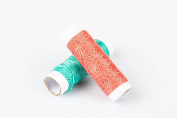 Colorful spools of sewing threads on a white background - Photo, Image