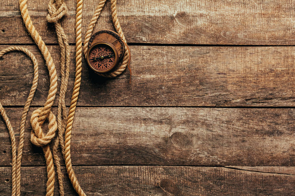 ship ropes and compass on wooden background - Foto, imagen