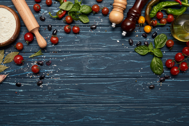 top view of fresh raw vegetables, spices and rolling pin on wooden background  - Foto, Imagem
