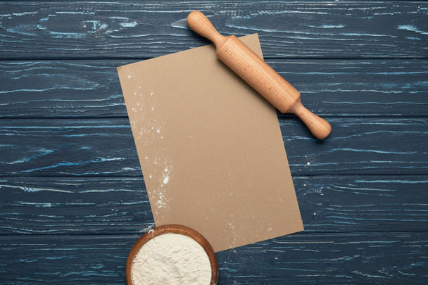 top view of blank card, rolling pin and bowl with flour on wooden surface - Photo, Image