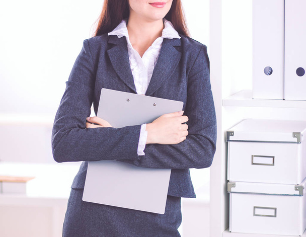 Portrait of business woman standing with crossed arms in office. - Photo, image