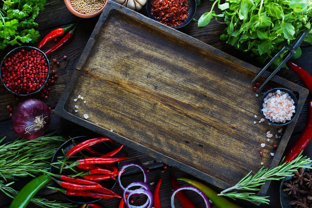 wooden board surrounded vegetables and greens  - Φωτογραφία, εικόνα