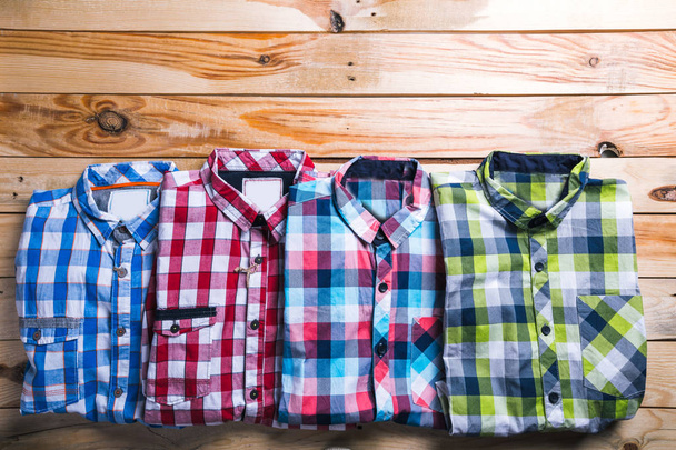 shirts plaid in plan with wooden background - Valokuva, kuva