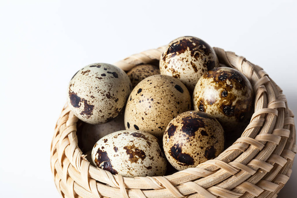 Fresh quail eggs at wooden plate closeup - Fotó, kép