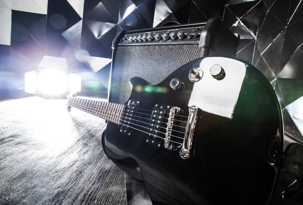 electric guitar and classic amplifier on a dark background - Фото, изображение