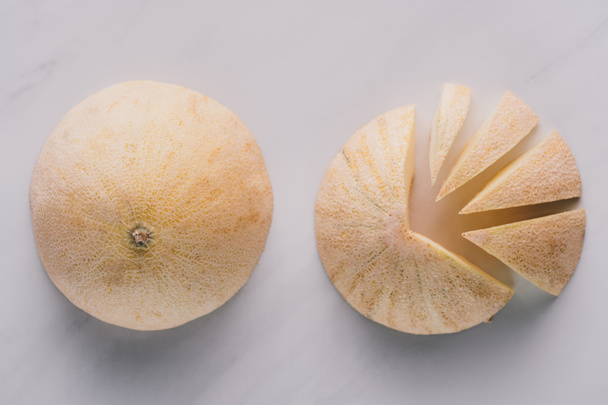 top view of whole and sliced honeydew melons on white - Photo, Image