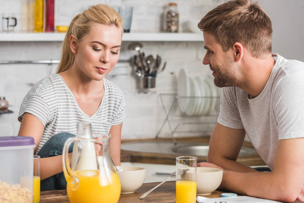 young couple having breakfast in kitchen  - Fotoğraf, Görsel