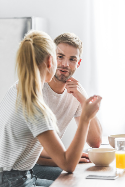 couple looking at each other during breakfast in kitchen - Foto, Bild